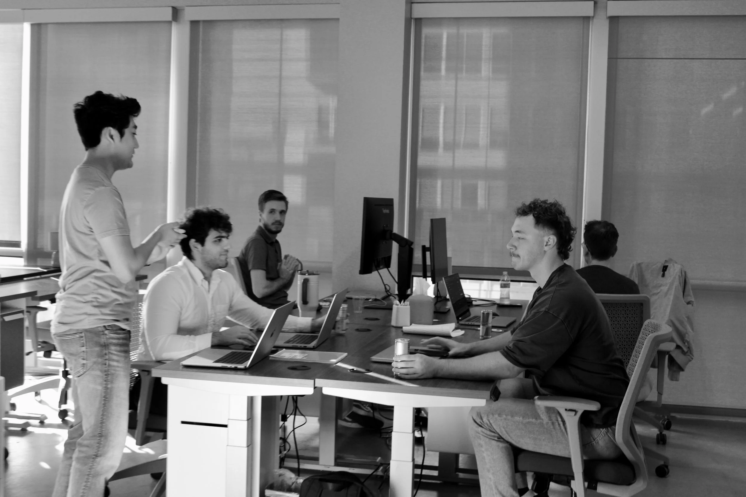Historical photo of people working together at desks in the Foundry space